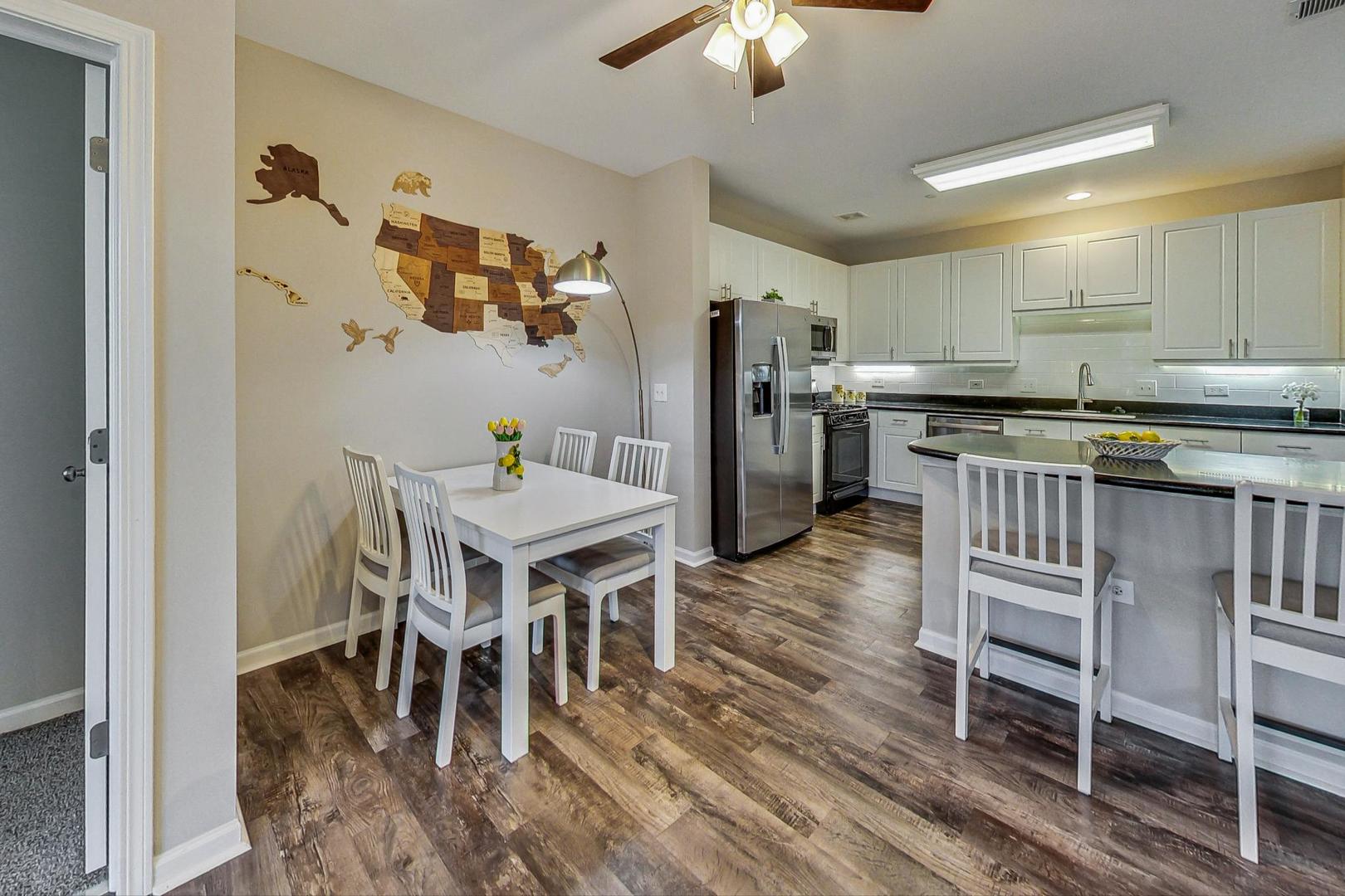640 McHenry Road, Unit 203 Wheeling, IL 60090 - Photo 16 of 41 a living room with stainless steel appliances furniture a dining table and chairs