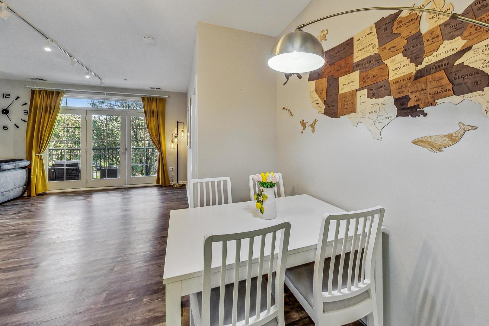 640 McHenry Road, Unit 203 Wheeling, IL 60090 - Photo 18 of 41 a bedroom with furniture and wooden floor