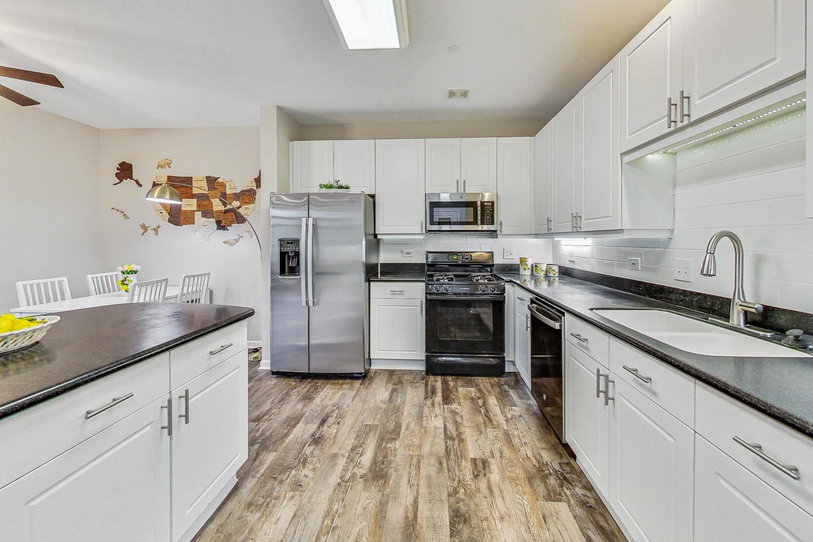 640 McHenry Road, Unit 203 Wheeling, IL 60090 - Photo 20 of 41 a kitchen with granite countertop stainless steel appliances a sink cabinets and a counter space