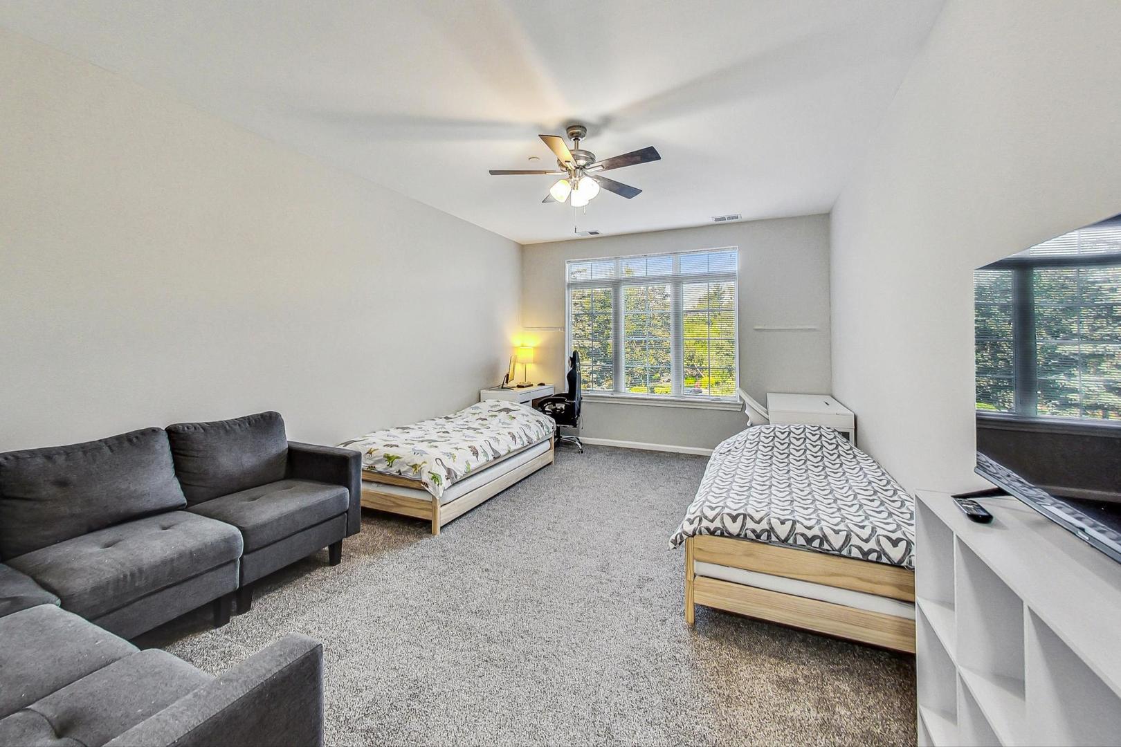640 McHenry Road, Unit 203 Wheeling, IL 60090 - Photo 23 of 41 a living room with furniture and a chandelier