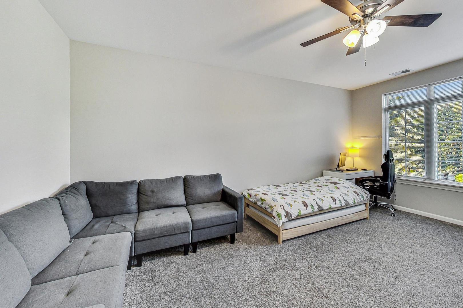 640 McHenry Road, Unit 203 Wheeling, IL 60090 - Photo 24 of 41 a bedroom with bed couch and window