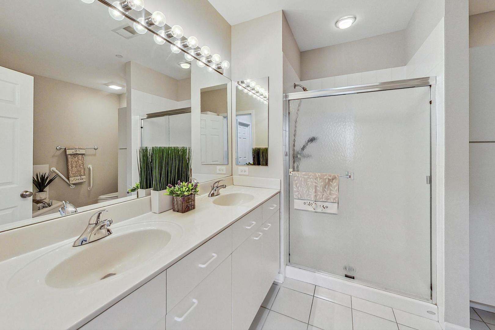 640 McHenry Road, Unit 203 Wheeling, IL 60090 - Photo 26 of 41 a bathroom with a double vanity sink mirror and shower