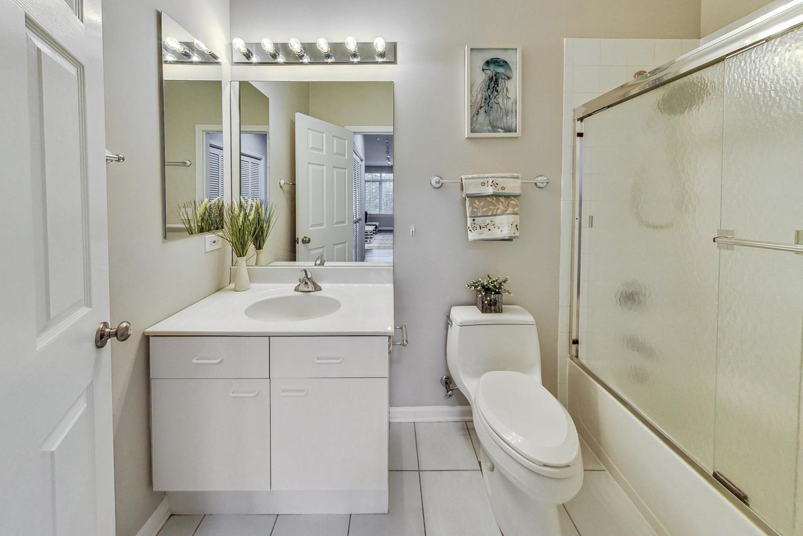 640 McHenry Road, Unit 203 Wheeling, IL 60090 - Photo 30 of 41 a bathroom with a sink a toilet and shower