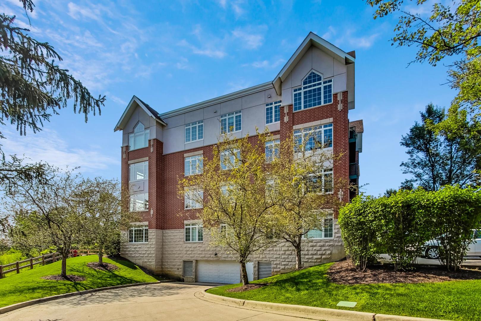 640 McHenry Road, Unit 203 Wheeling, IL 60090 - Photo 38 of 41 a front view of a house with garden