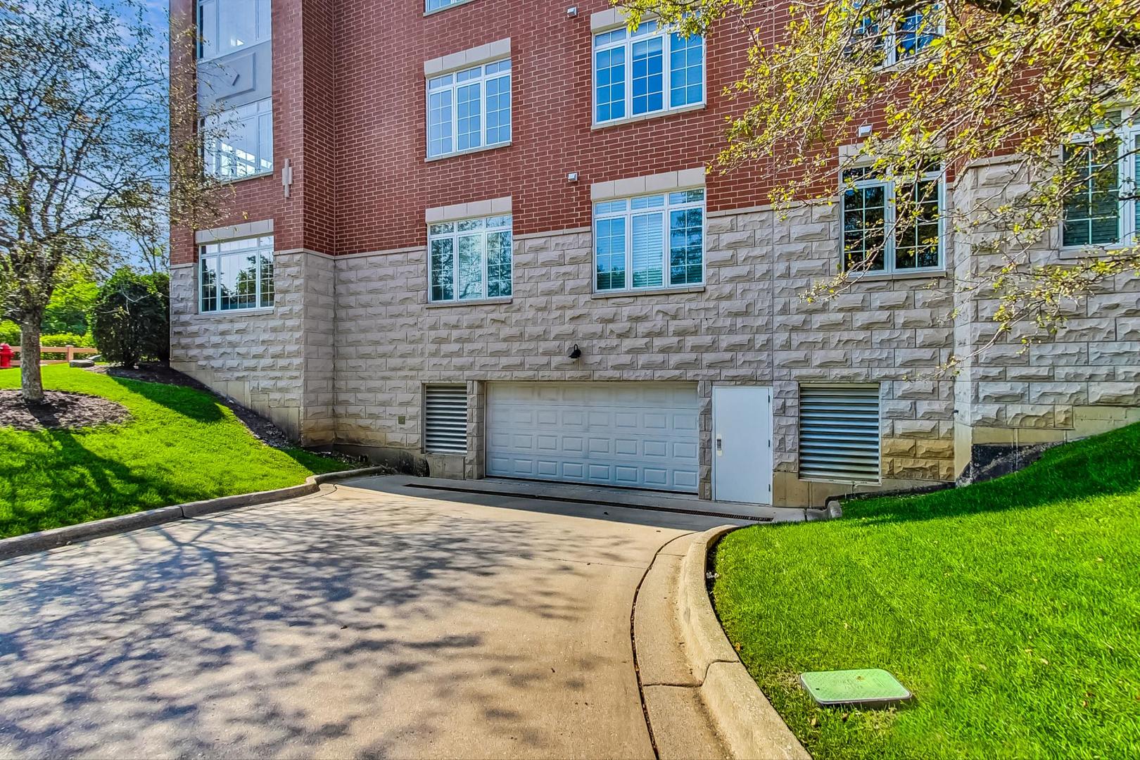 640 McHenry Road, Unit 203 Wheeling, IL 60090 - Photo 39 of 41 a front view of a house with a yard
