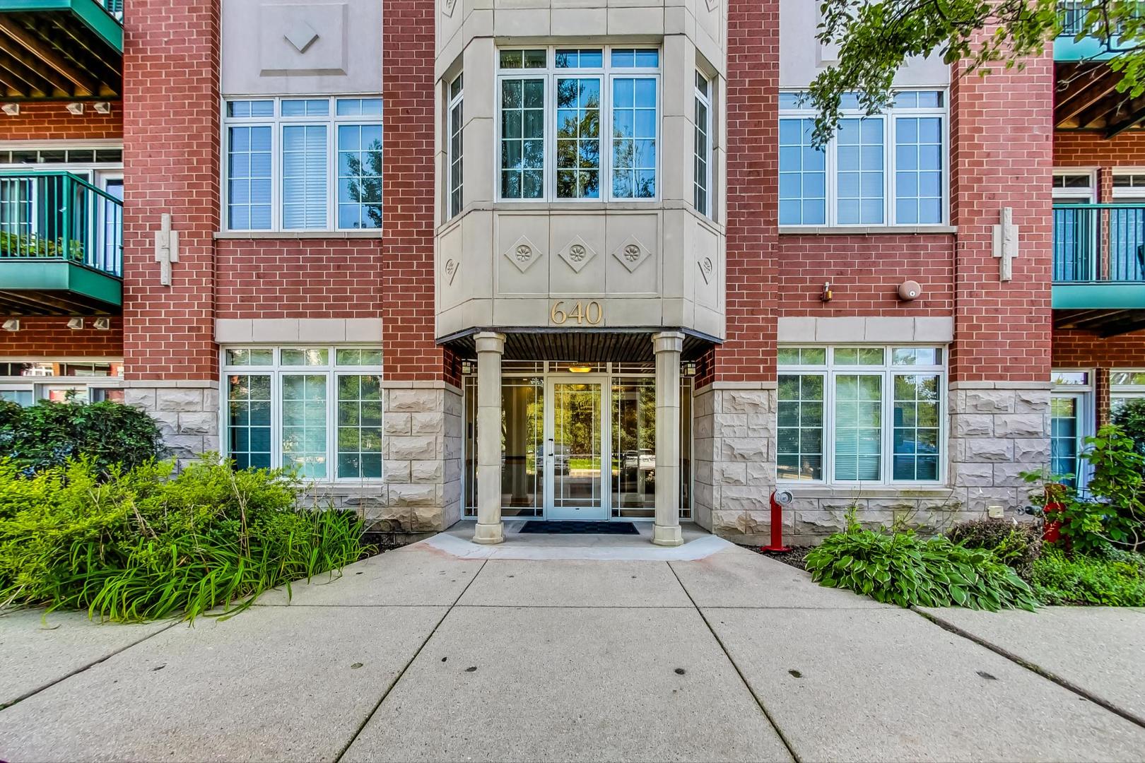 640 McHenry Road, Unit 203 Wheeling, IL 60090 - Photo 5 of 41 front view of a brick house with a large windows