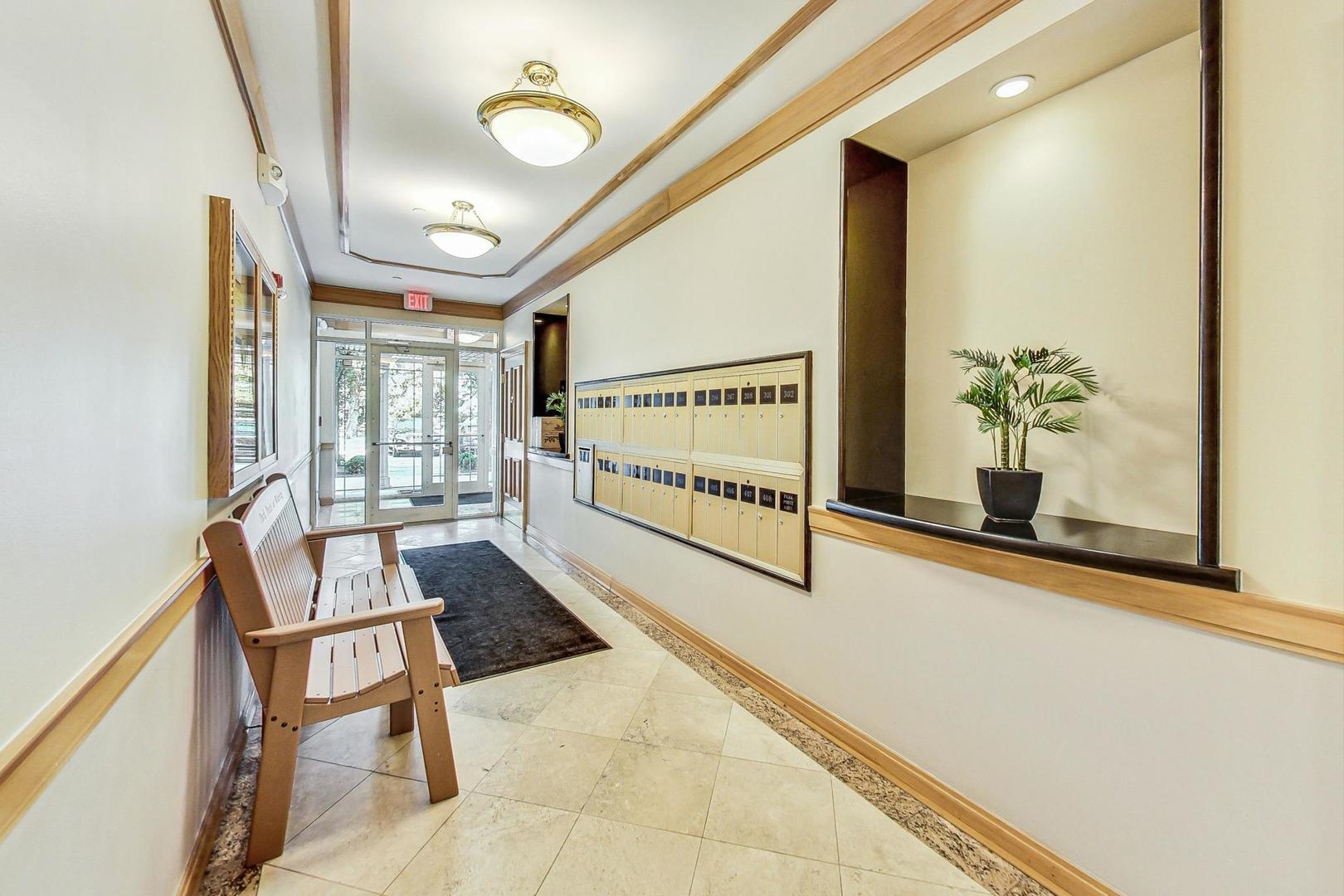 640 McHenry Road, Unit 203 Wheeling, IL 60090 - Photo 8 of 41 a view of an entryway with wooden floor