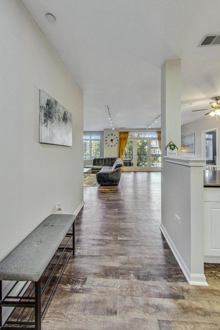 640 McHenry Road, Unit 203 Wheeling, IL 60090 - Photo 10 of 41 a living room with furniture and a large window