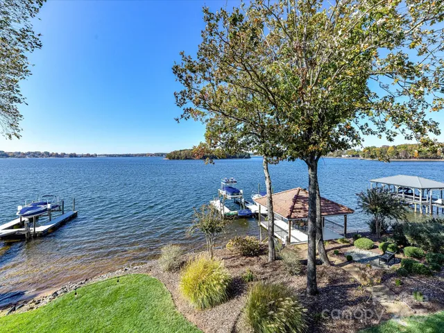 a spacious bedroom with a bed and wooden floor