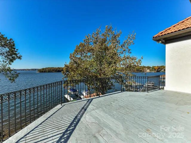 a living room with furniture a large window and a fireplace