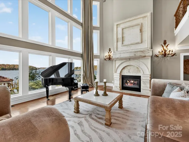 a view of staircase with lots of frames and a chandelier