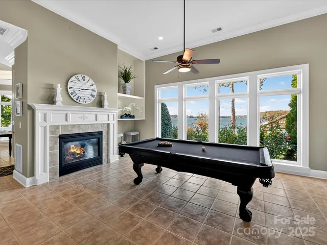 a living room with furniture large window and fireplace