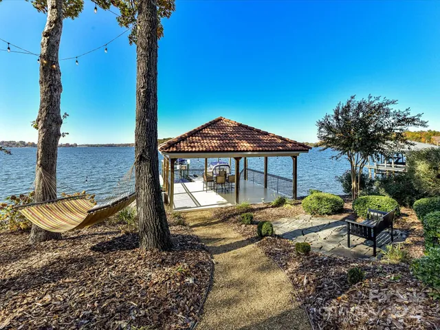 a front view of a house with a yard and balcony
