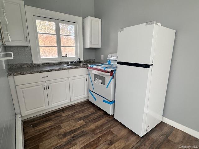 9 Elm Road Wurtsboro, NY 12790 - Photo 3 of 13 Kitchen featuring white cabinets, white appliances, dark countertops,