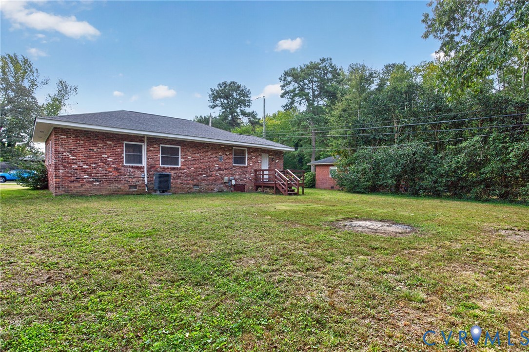 1118 Andros Road Richmond, VA 23225 - Photo 4 of 28 Brick exterior with white-framed windows, a dark s