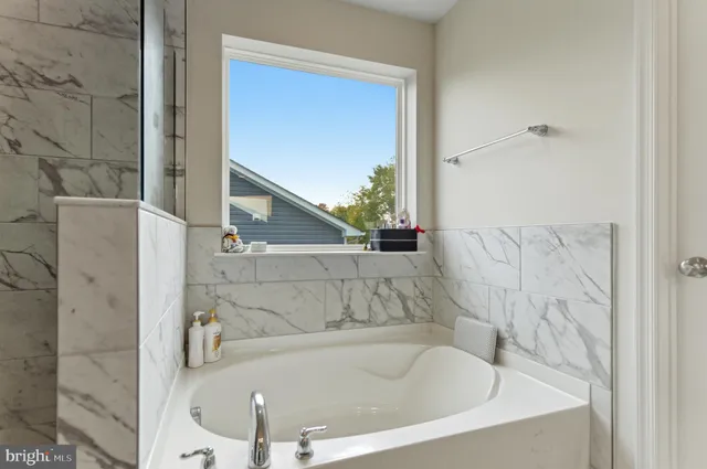a bathroom with bathtub and shower