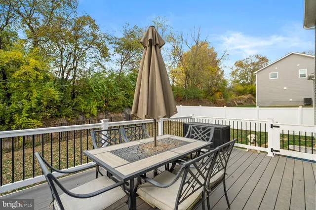 a view of a deck with two chair and wooden floor