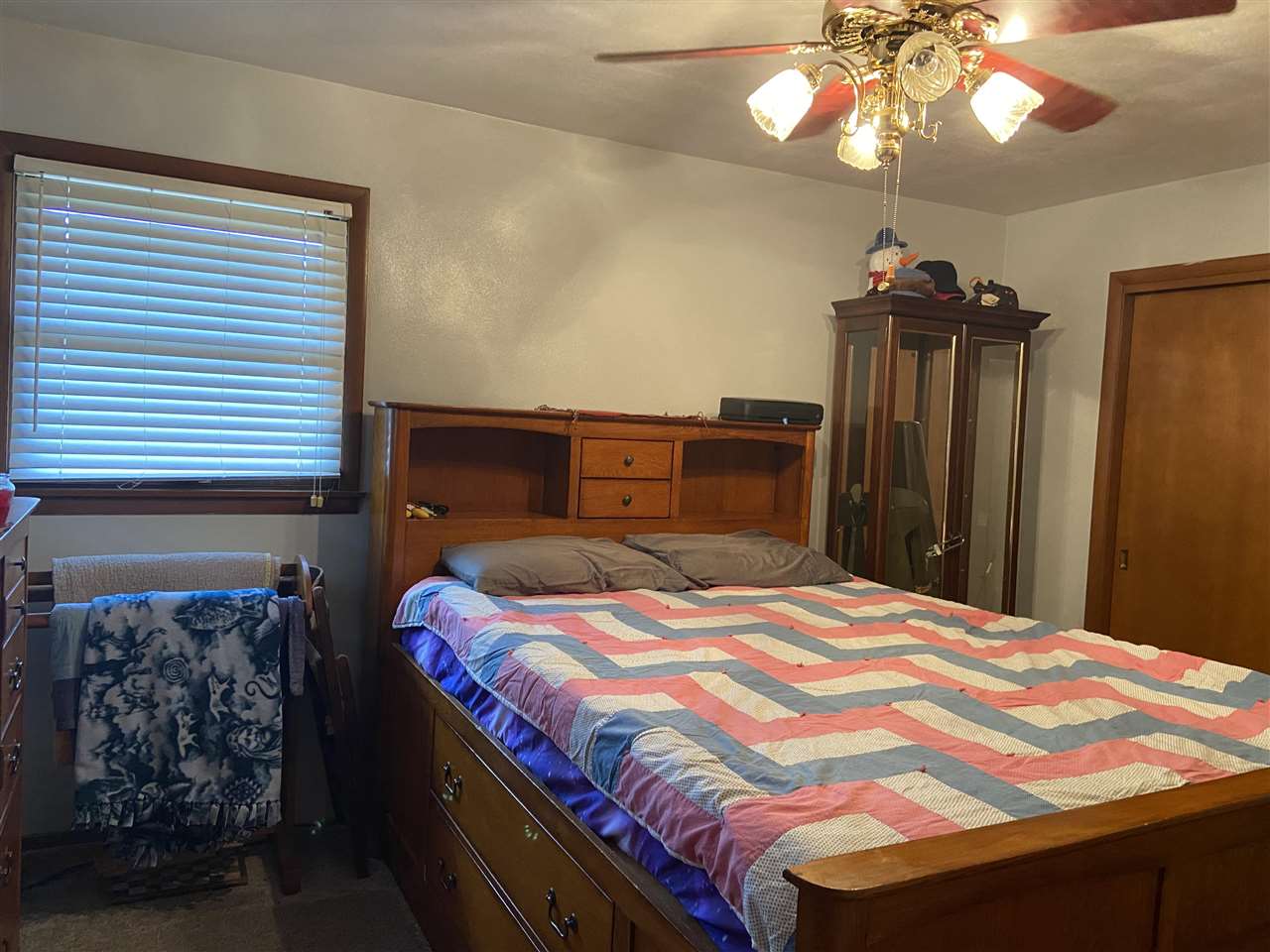 3309 Spring Creek Road Rockford, IL 61107 - Photo 16 of 17 a bedroom with a bed and a chandelier