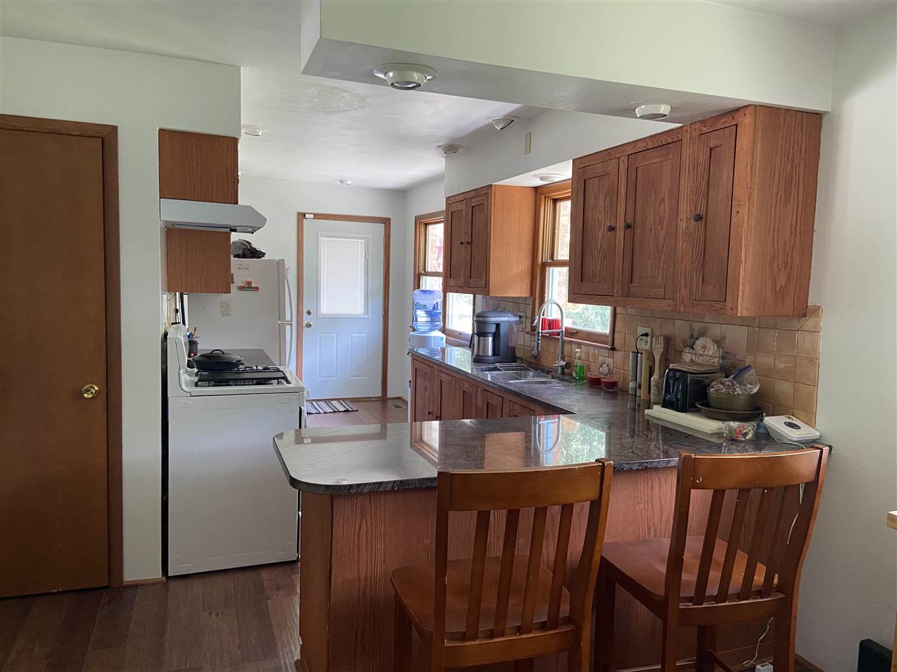 3309 Spring Creek Road Rockford, IL 61107 - Photo 5 of 17 a kitchen with granite countertop a dining table chairs cabinets and stainless steel appliances