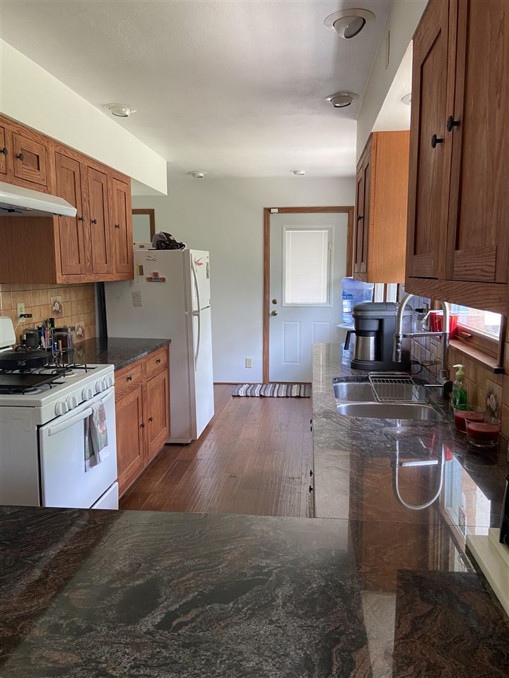 3309 Spring Creek Road Rockford, IL 61107 - Photo 7 of 17 a kitchen with stainless steel appliances granite countertop a sink a stove top oven a counter space and cabinets