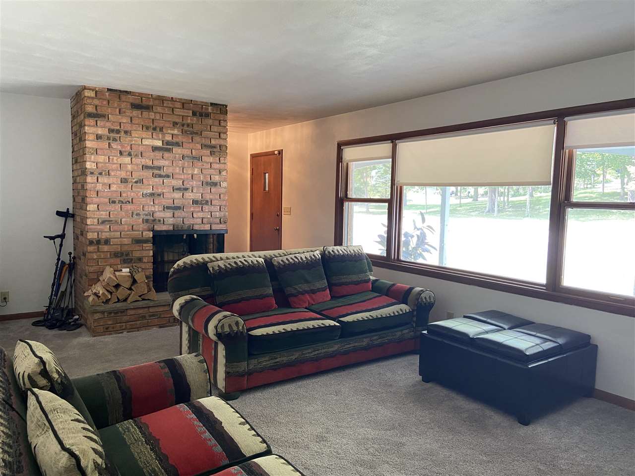 3309 Spring Creek Road Rockford, IL 61107 - Photo 9 of 17 a living room with furniture a fireplace and a large window