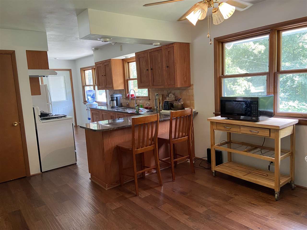3309 Spring Creek Road Rockford, IL 61107 - Photo 10 of 17 a kitchen with kitchen island a counter top space a sink a refrigerator and a large window
