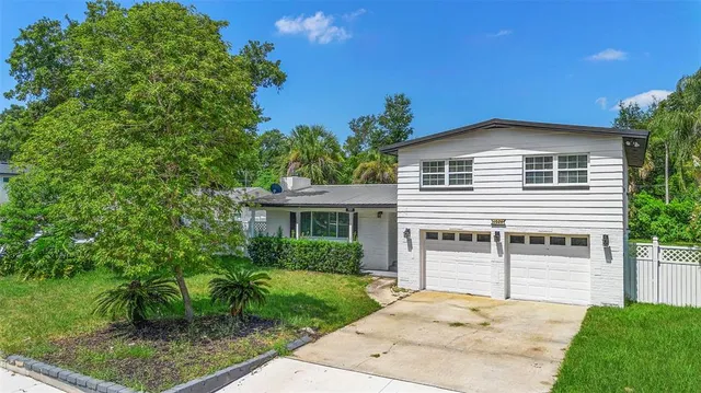 a front view of a house with a garden