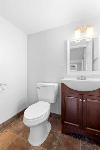 a bathroom with a sink a toilet and mirror