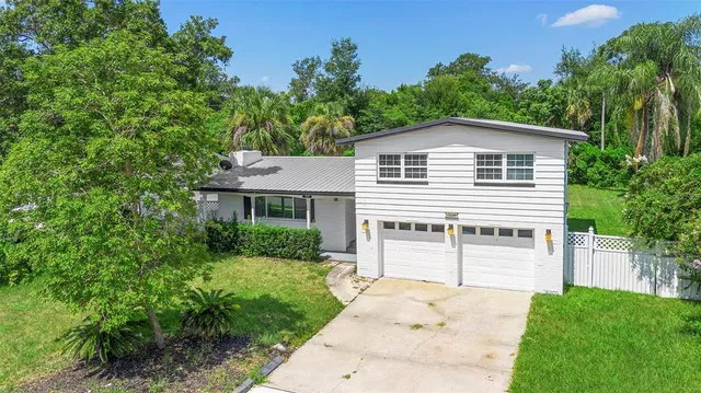 a front view of a house with a garden and plants