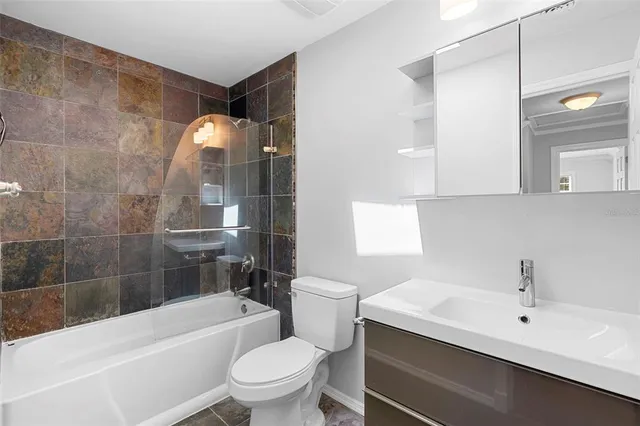 a bathroom with a sink a toilet and a bathtub