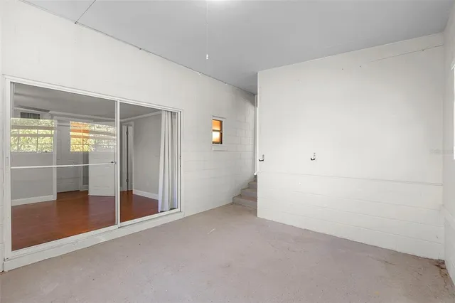 an empty room with sliding glass door