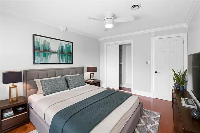 a bedroom with a large bed and a chandelier