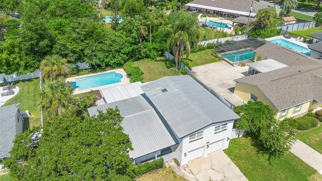 an aerial view of a house with a yard