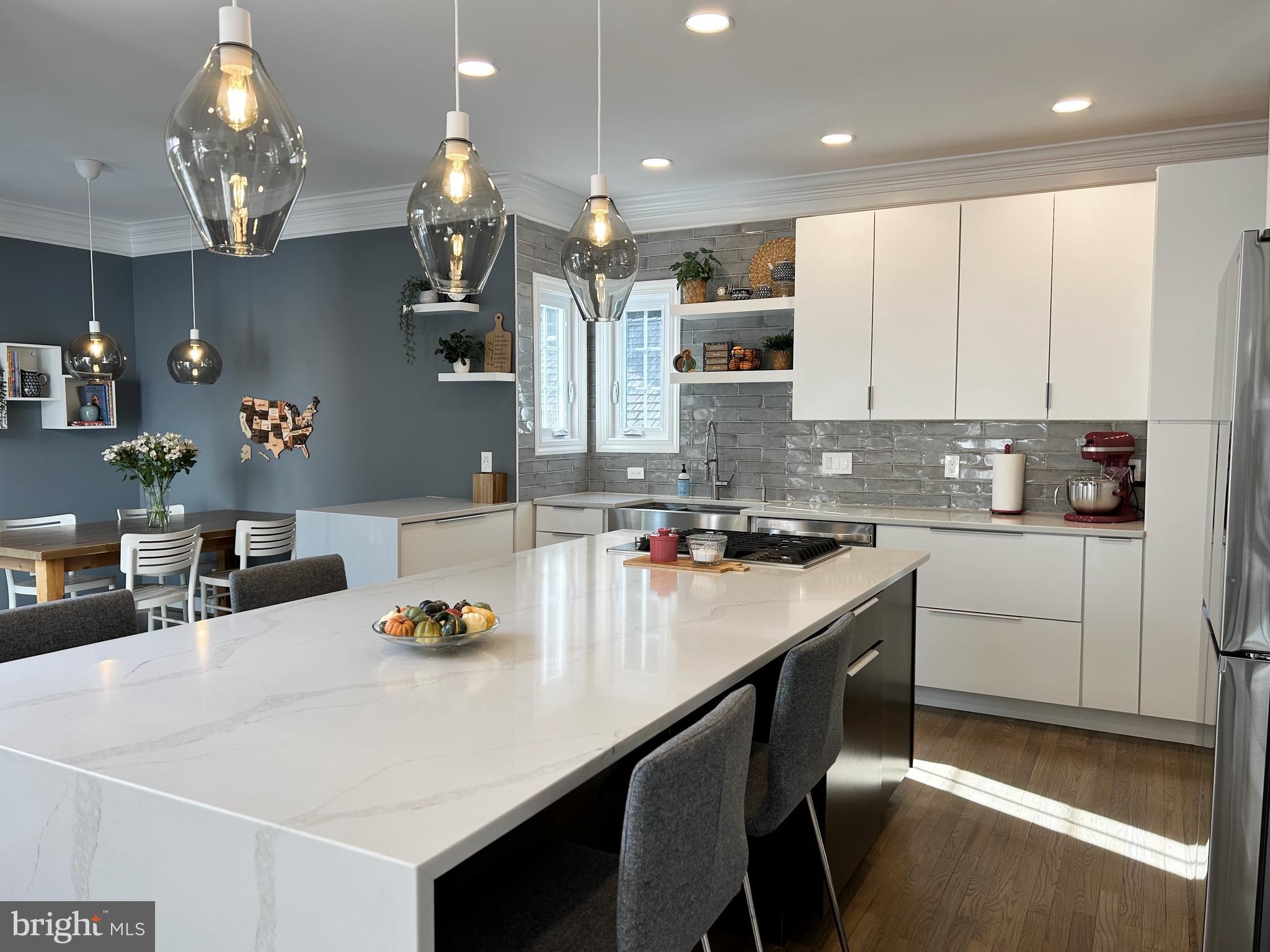 515 Chestertown Street Gaithersburg, MD 20878 - Photo 20 of 50 a kitchen with kitchen island granite countertop a sink a counter space appliances and cabinets