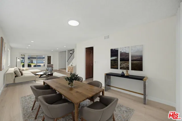 a spacious bedroom with a bed and glass walk in closet