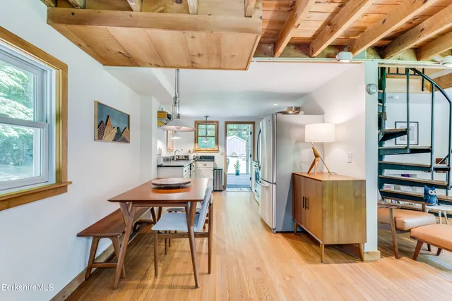 a view of a dining room with furniture and a window