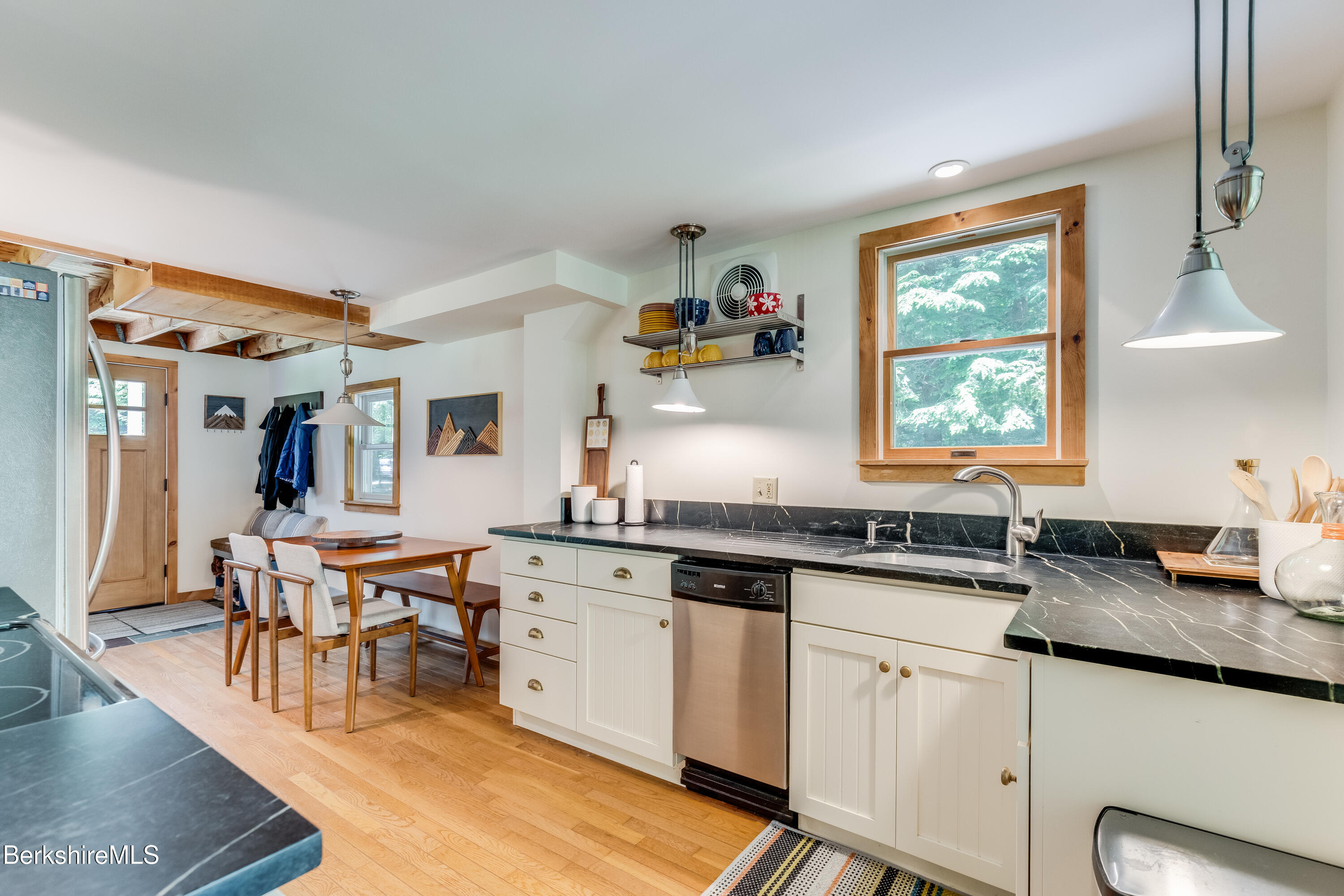 14 Norwalk Acres Road Monterey, MA 01245 - Photo 17 of 56 a kitchen with granite countertop lots of white cabinets stainless steel appliances a large window and a counter space
