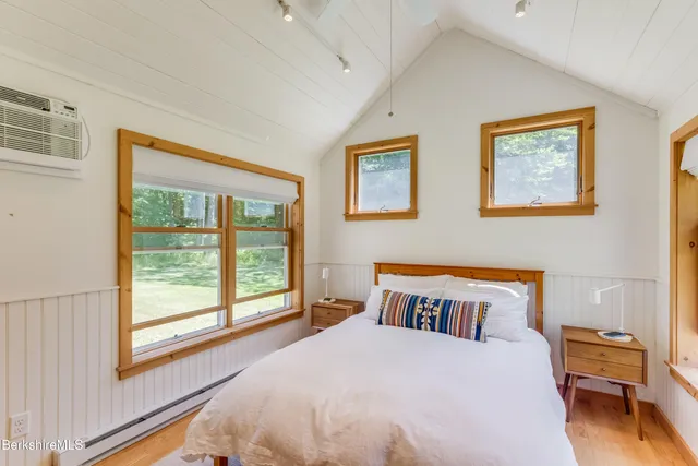 a bedroom with a large bed and a window