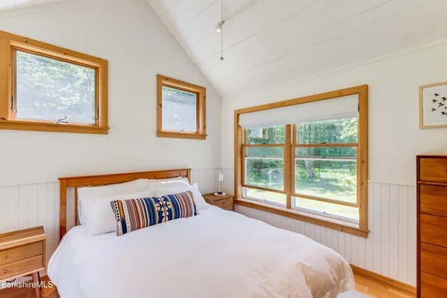 a bedroom with furniture and a window