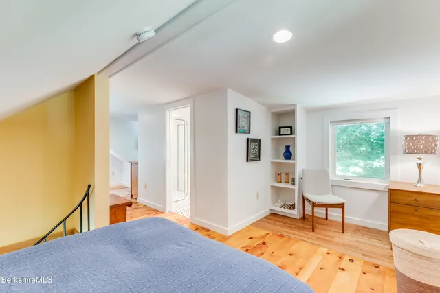 a living room with furniture and a dresser