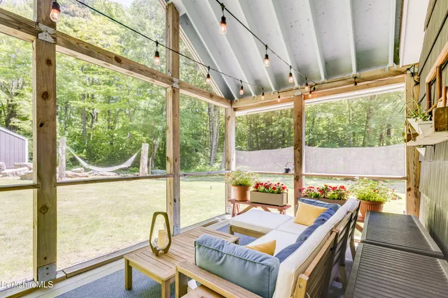 a view of a house with a yard garage and tree