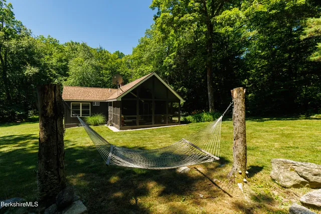 a view of a house with swimming pool and a yard
