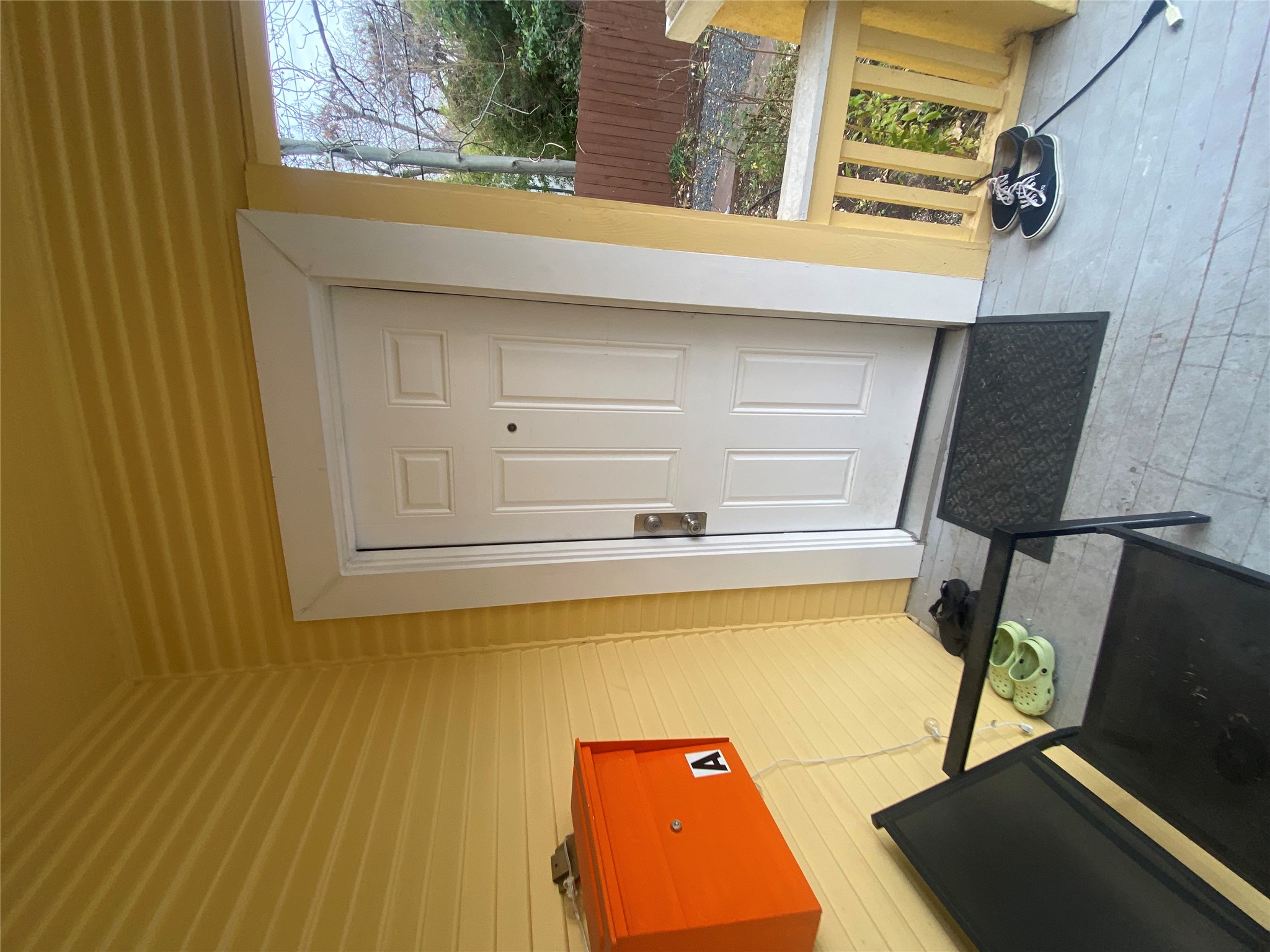 3010 Fruth Street, Unit A Austin, TX 78705 - Photo 2 of 39 Front entry featuring a paneled door with white trim, yellow siding, and a covered porch