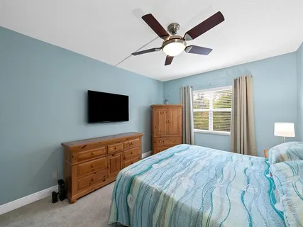 a bedroom with a large bed and a flat screen tv