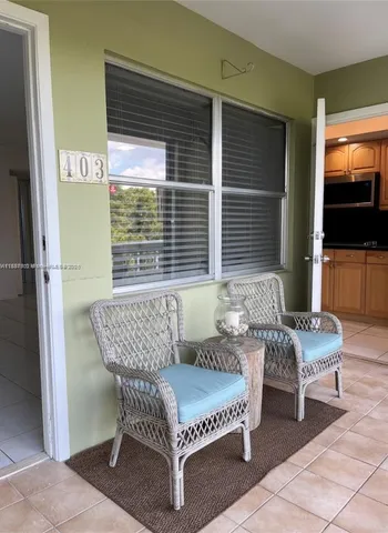 a outdoor living space with furniture and a flat screen tv