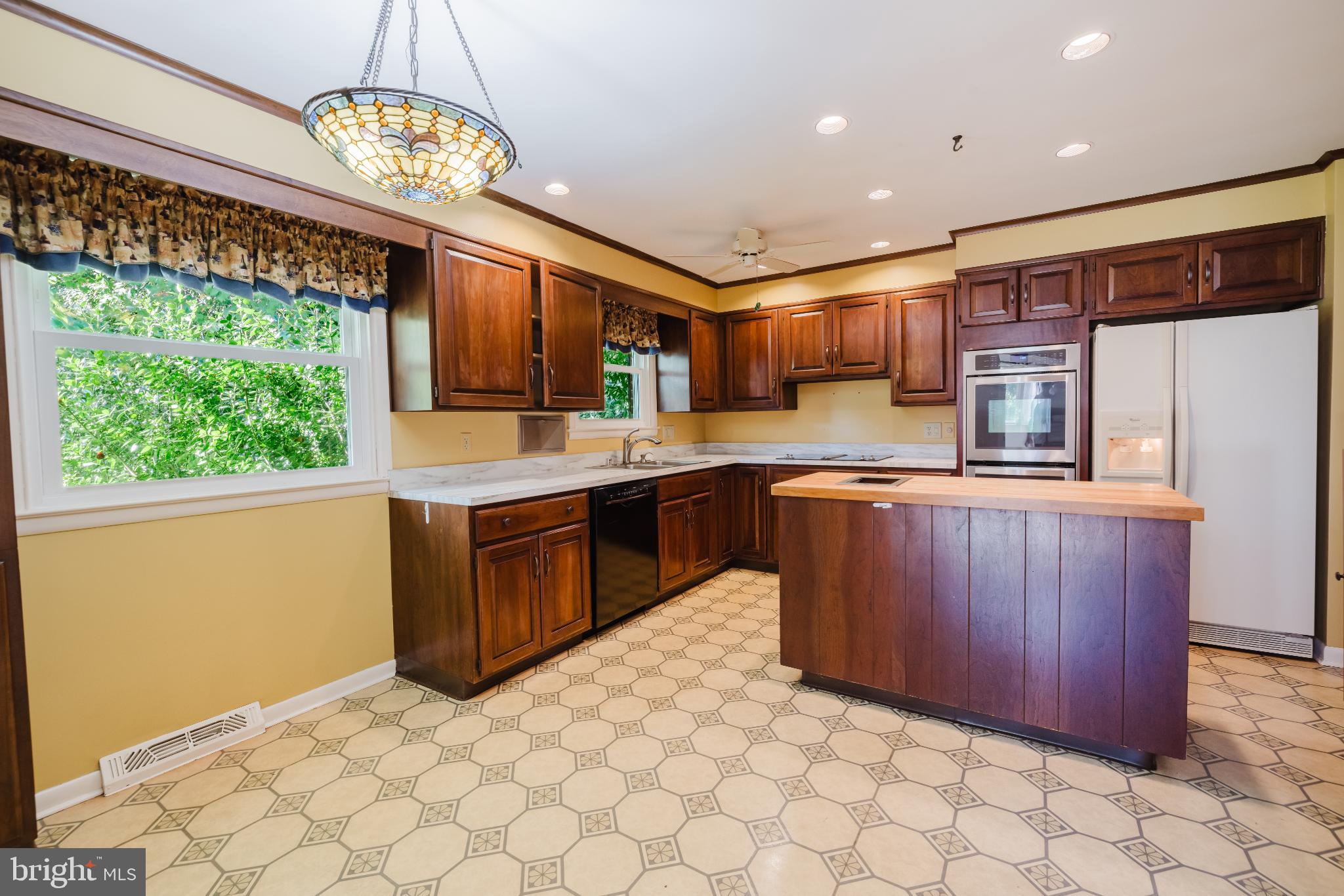 814 West Padonia Road Cockeysville, MD 21030 - Photo 8 of 28 a kitchen with stainless steel appliances a sink a stove a refrigerator cabinets and a dining table