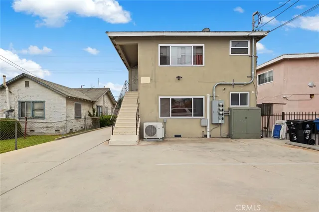 an aerial view of a house with swimming pool and outdoor seating