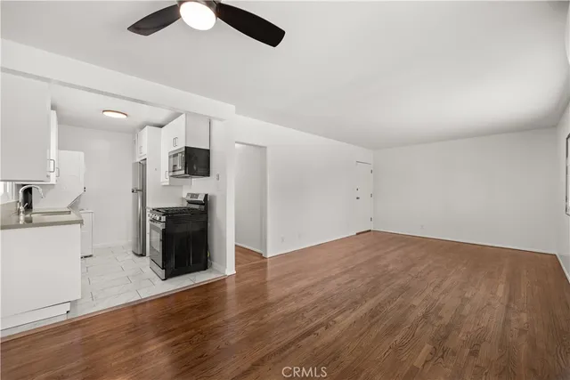 a kitchen with stainless steel appliances granite countertop a sink stove and microwave