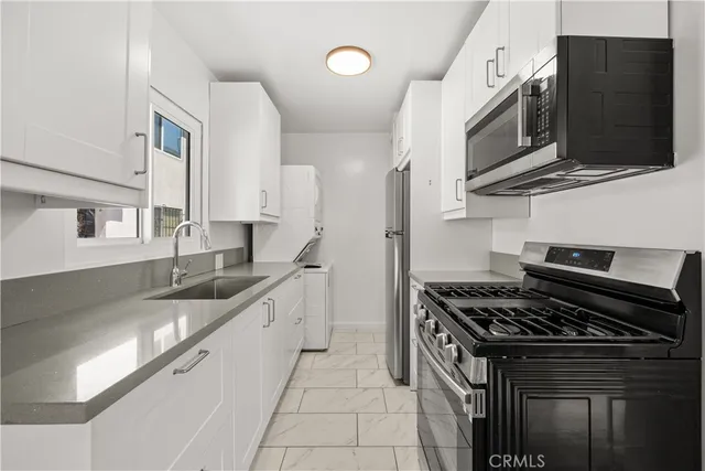 a view of a room with wooden floor closet and windows