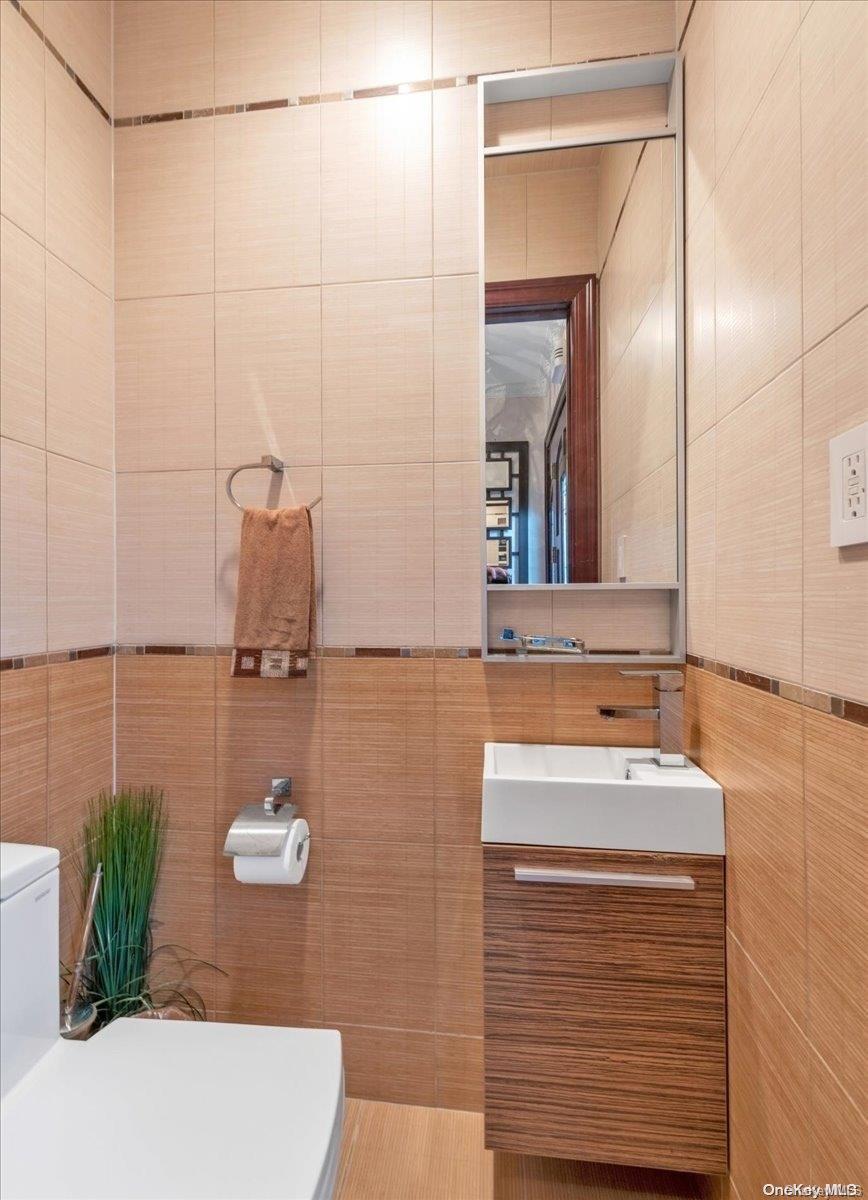 153-02 77th Avenue Queens, NY 11367 - Photo 13 of 23 a bathroom with a sink and a mirror